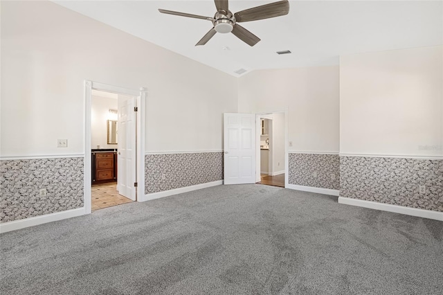 1701 Palmer Ave, Winter Park, FL 32789 - unfurnished room with visible vents, lofted ceiling, light carpet, wainscoting, and a ceiling fan