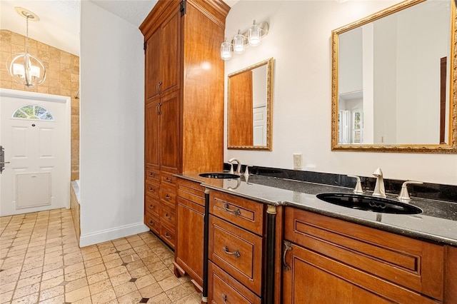 1701 Palmer Ave, Winter Park, FL 32789 - bathroom featuring double vanity, a washtub, baseboards, and a sink
