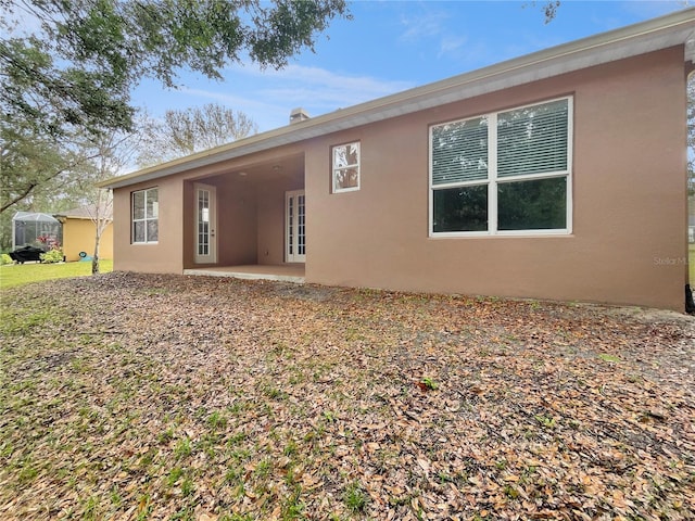 30411 Gidran Ter, Mount Dora, FL 32757 - back of property with a patio area, french doors, and stucco siding