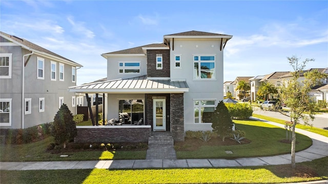 14004 Gullstrand Ave, Orlando, FL 32827 - view of front of property featuring metal roof, stone siding, a standing seam roof, and stucco siding