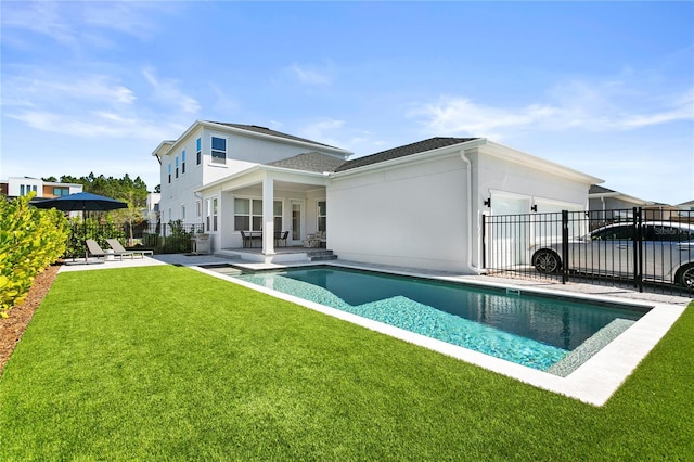 14004 Gullstrand Ave, Orlando, FL 32827 - back of property featuring stucco siding, fence, a fenced in pool, a yard, and a patio area