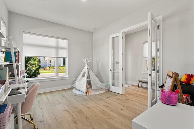 14004 Gullstrand Ave, Orlando, FL 32827 - recreation room featuring french doors, baseboards, and wood finished floors