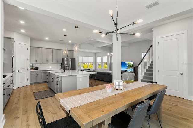14004 Gullstrand Ave, Orlando, FL 32827 - dining area with visible vents, light wood-style floors, recessed lighting, and an inviting chandelier