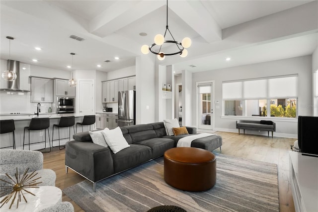 14004 Gullstrand Ave, Orlando, FL 32827 - living area with light wood finished floors, visible vents, and beam ceiling