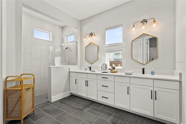 14004 Gullstrand Ave, Orlando, FL 32827 - bathroom with baseboards, double vanity, tile patterned flooring, and walk in shower