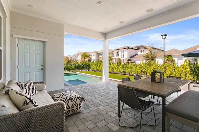 14004 Gullstrand Ave, Orlando, FL 32827 - view of patio with fence, outdoor dining space, a fenced in pool, and a residential view