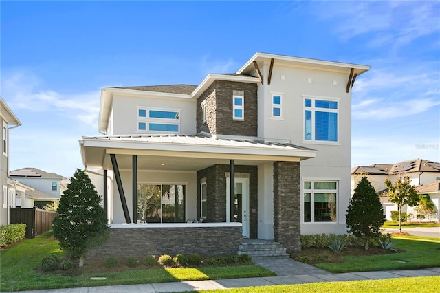 14004 Gullstrand Ave, Orlando, FL 32827 - contemporary house featuring a standing seam roof, stucco siding, fence, stone siding, and metal roof