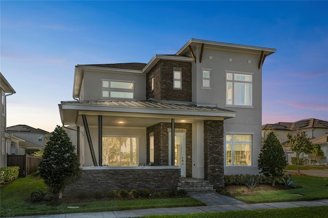 14004 Gullstrand Ave, Orlando, FL 32827 - contemporary home with stone siding, a standing seam roof, and stucco siding