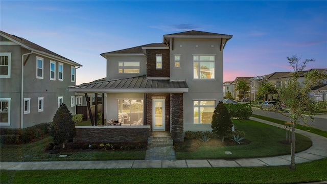 14004 Gullstrand Ave, Orlando, FL 32827 - view of front of property featuring stucco siding, a porch, a standing seam roof, and metal roof
