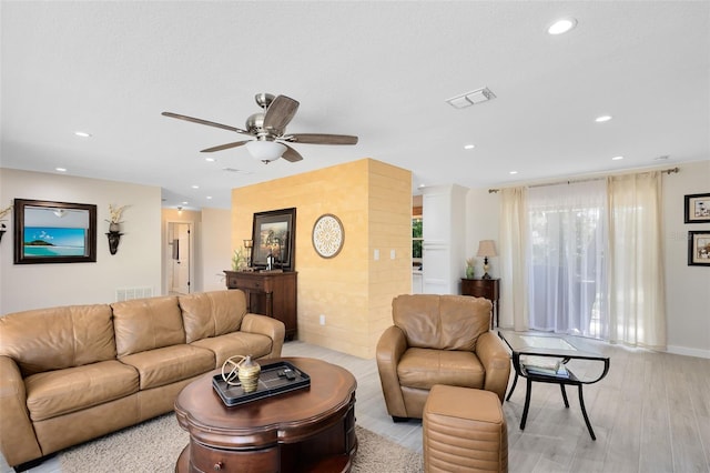 living room featuring recessed lighting, a ceiling fan, visible vents, and light wood finished floors