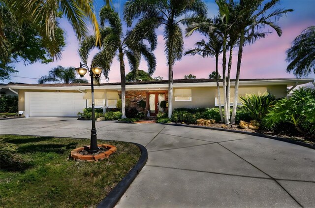 view of front of property with a garage, driveway, and stucco siding