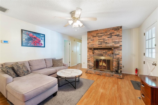 4366 Roanne Dr, Orlando, FL 32817 - living room featuring visible vents, a textured ceiling, wood finished floors, and a ceiling fan
