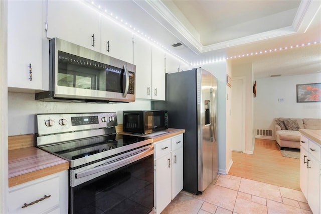 4366 Roanne Dr, Orlando, FL 32817 - kitchen featuring white cabinetry, a raised ceiling, visible vents, and appliances with stainless steel finishes
