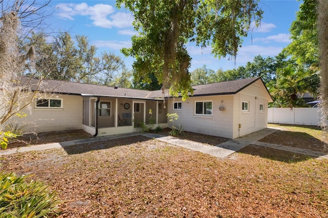 4366 Roanne Dr, Orlando, FL 32817 - back of property with fence, concrete block siding, a shingled roof, and a sunroom