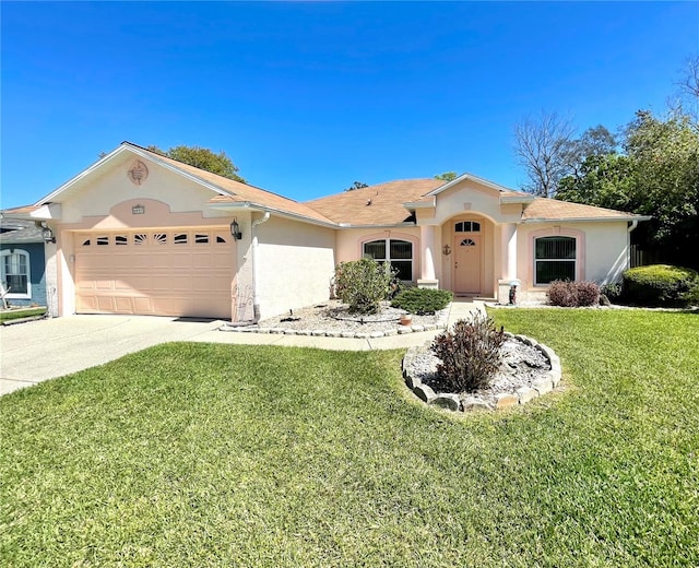 view of front facade with concrete driveway, an attached garage, stucco siding, and a front yard