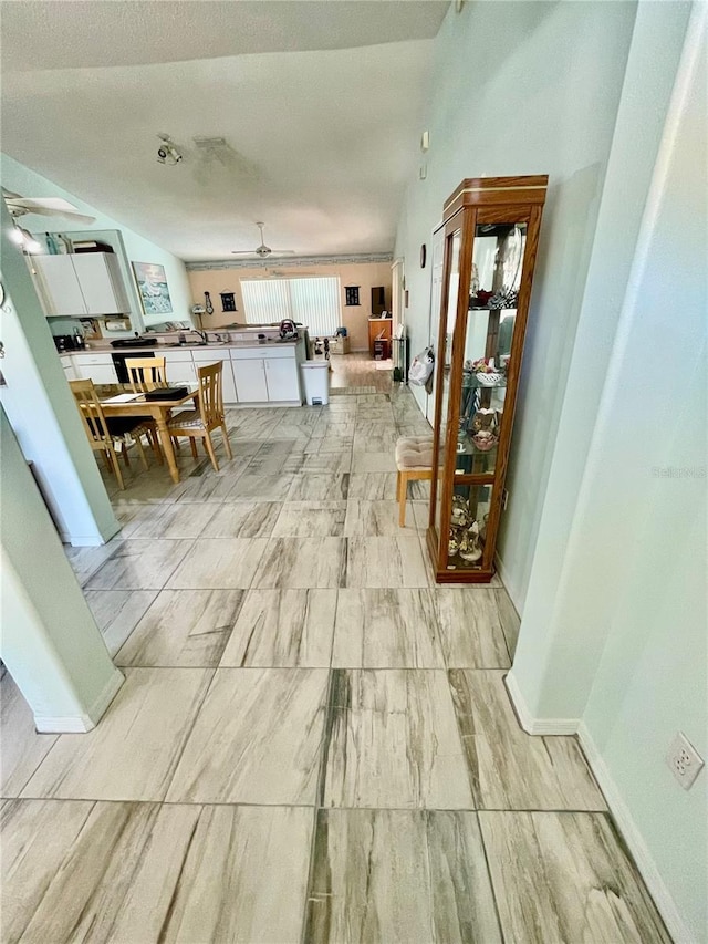 hall featuring baseboards