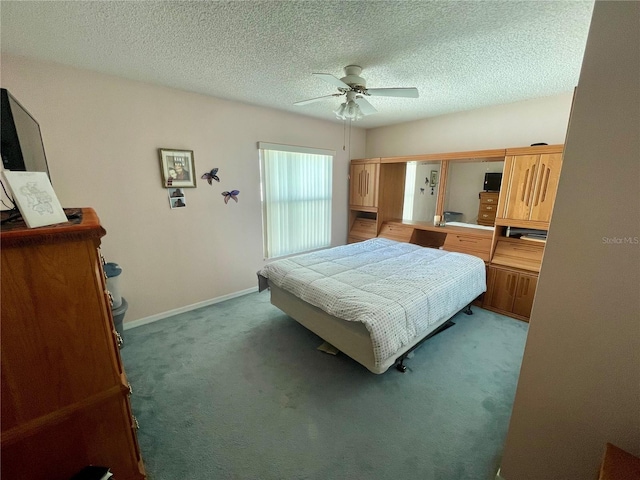 bedroom featuring ceiling fan, a textured ceiling, carpet floors, and baseboards