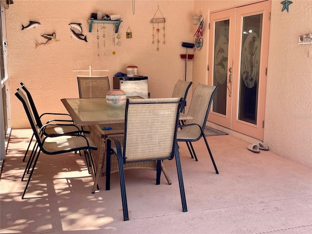 view of patio featuring outdoor dining area and french doors