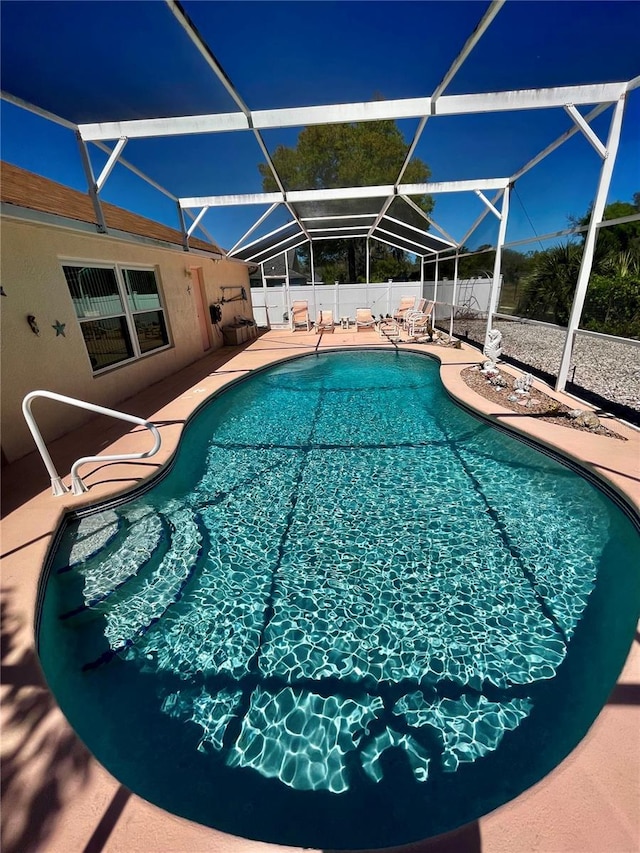 view of pool featuring a patio area, glass enclosure, a fenced in pool, and fence