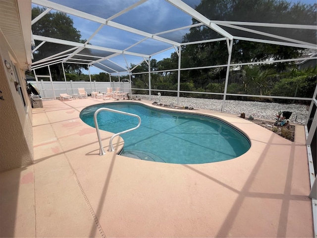 view of swimming pool featuring a patio area, a lanai, a fenced backyard, and a fenced in pool