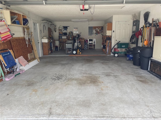 garage featuring electric panel and a garage door opener