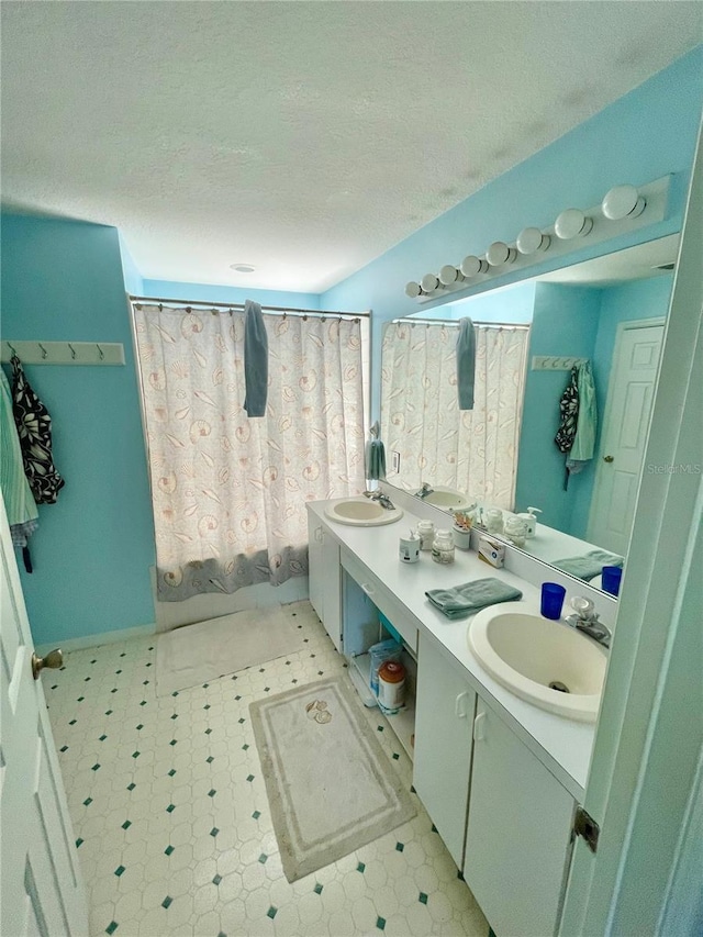 6037 Hickory Grove Ln, Port Orange, FL 32128 - bathroom with double vanity, tile patterned floors, and a textured ceiling