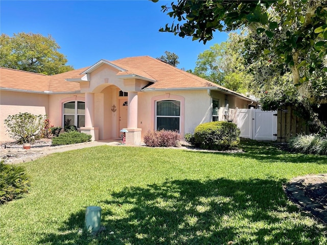 6037 Hickory Grove Ln, Port Orange, FL 32128 - view of front of home featuring stucco siding and a gate