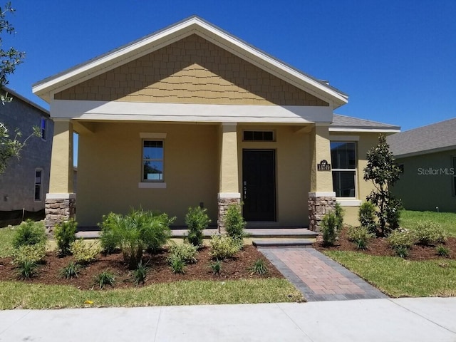 view of front facade with stucco siding and stone siding