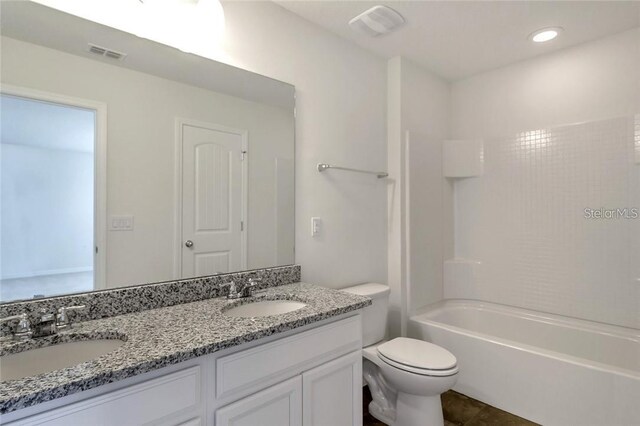 full bath featuring visible vents, a sink, double vanity, and toilet