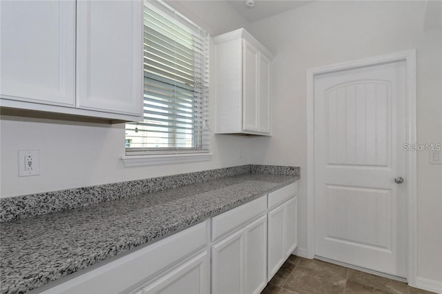 kitchen with white cabinets and light stone counters