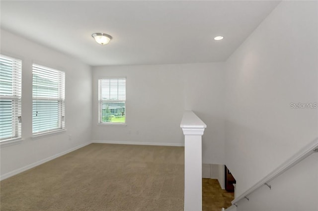unfurnished room featuring recessed lighting, baseboards, and light carpet