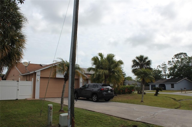 855 San Pedro Ct, Kissimmee, FL 34758 - view of front of home with a front yard, a gate, driveway, and a garage