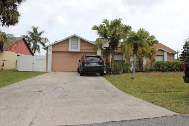 855 San Pedro Ct, Kissimmee, FL 34758 - view of front of property with concrete driveway, fence, a gate, a front lawn, and a garage