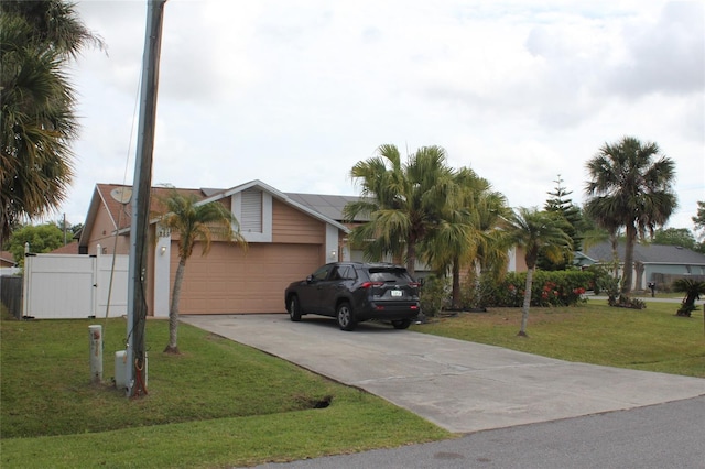 855 San Pedro Ct, Kissimmee, FL 34758 - view of front facade with fence, a front yard, an attached garage, and concrete driveway