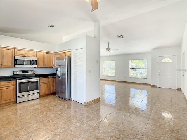 855 San Pedro Ct, Kissimmee, FL 34758 - kitchen with stainless steel appliances, baseboards, dark countertops, visible vents, and ceiling fan
