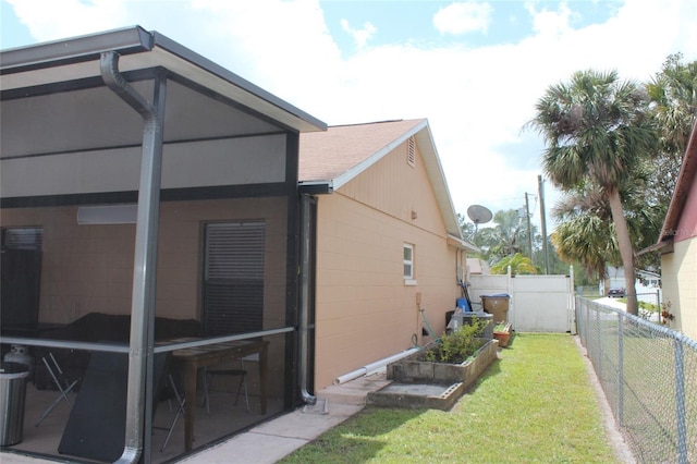 855 San Pedro Ct, Kissimmee, FL 34758 - view of home's exterior with concrete block siding, a fenced backyard, a vegetable garden, and a lawn