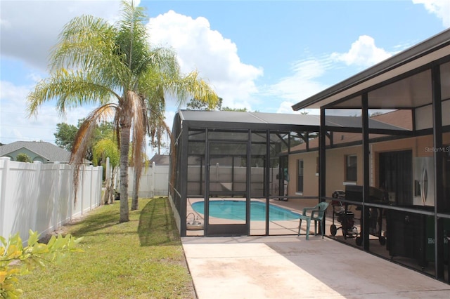 855 San Pedro Ct, Kissimmee, FL 34758 - view of swimming pool featuring a patio, glass enclosure, a fenced in pool, a fenced backyard, and a lawn