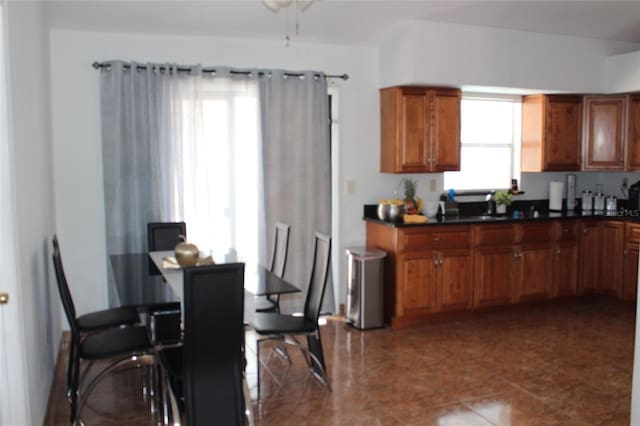 855 San Pedro Ct, Kissimmee, FL 34758 - kitchen featuring dark countertops and brown cabinetry