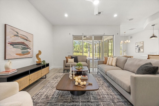 living area featuring recessed lighting, visible vents, light wood-style flooring, and baseboards
