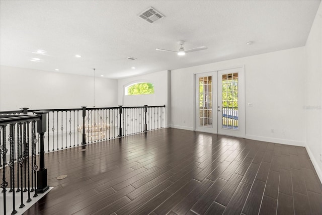 spare room with visible vents, baseboards, ceiling fan, and wood finished floors