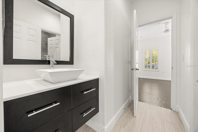 bathroom with baseboards and vanity