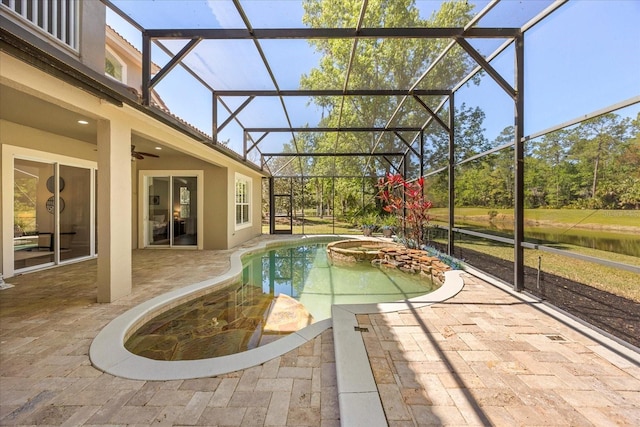 pool featuring glass enclosure, an in ground hot tub, a ceiling fan, and a patio