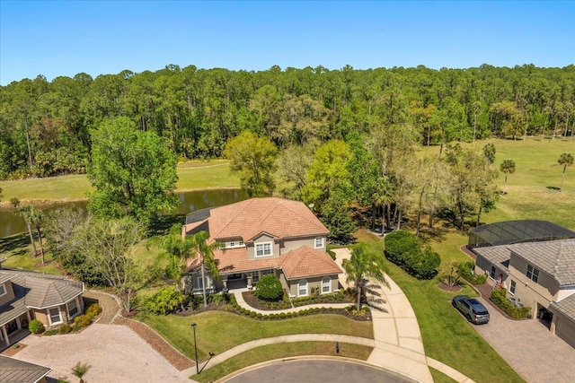 birds eye view of property featuring a water view and a view of trees