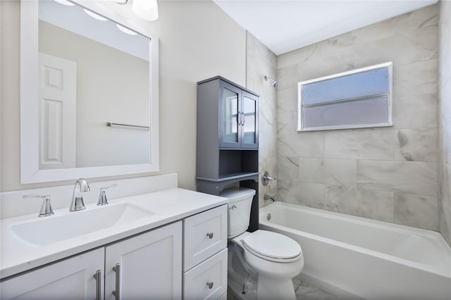full bathroom featuring vanity, toilet, marble finish floor, and bathtub / shower combination