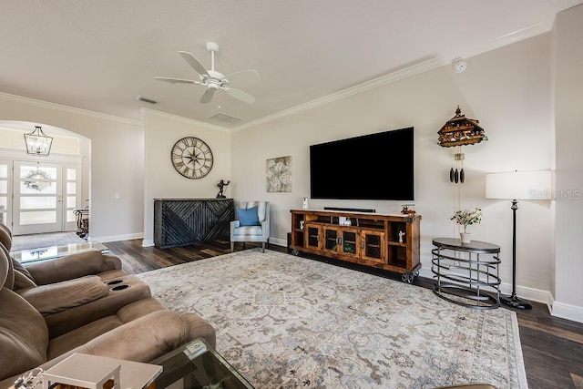 5729 Hickey Way, The Villages, FL 32163 - living area featuring crown molding, dark wood finished floors, ceiling fan with notable chandelier, visible vents, and arched walkways