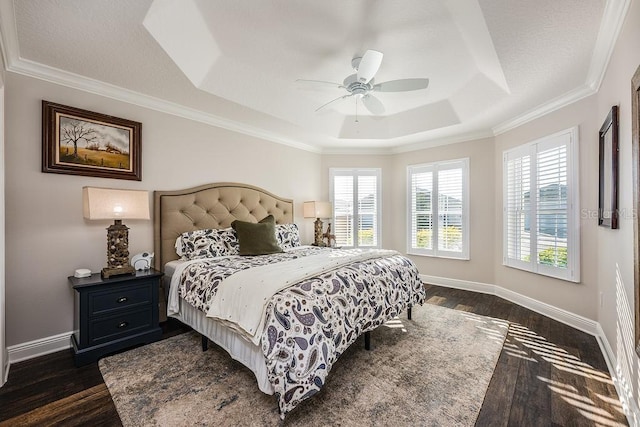 5729 Hickey Way, The Villages, FL 32163 - bedroom featuring a ceiling fan, a raised ceiling, dark wood-style floors, and baseboards