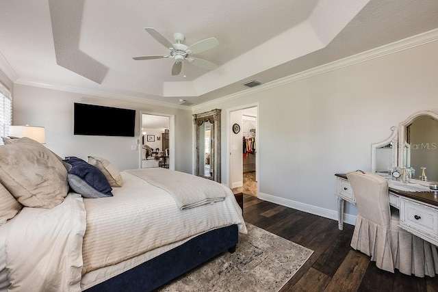 5729 Hickey Way, The Villages, FL 32163 - bedroom featuring dark wood-style flooring, visible vents, baseboards, ornamental molding, and a raised ceiling