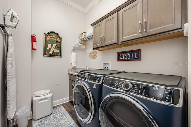 5729 Hickey Way, The Villages, FL 32163 - clothes washing area featuring crown molding, baseboards, cabinet space, dark wood finished floors, and washing machine and dryer