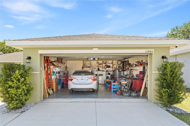 garage with concrete driveway