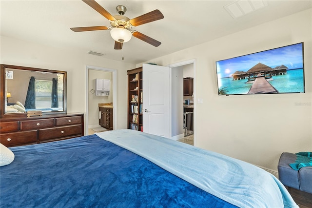 bedroom featuring ensuite bath, ceiling fan, and visible vents